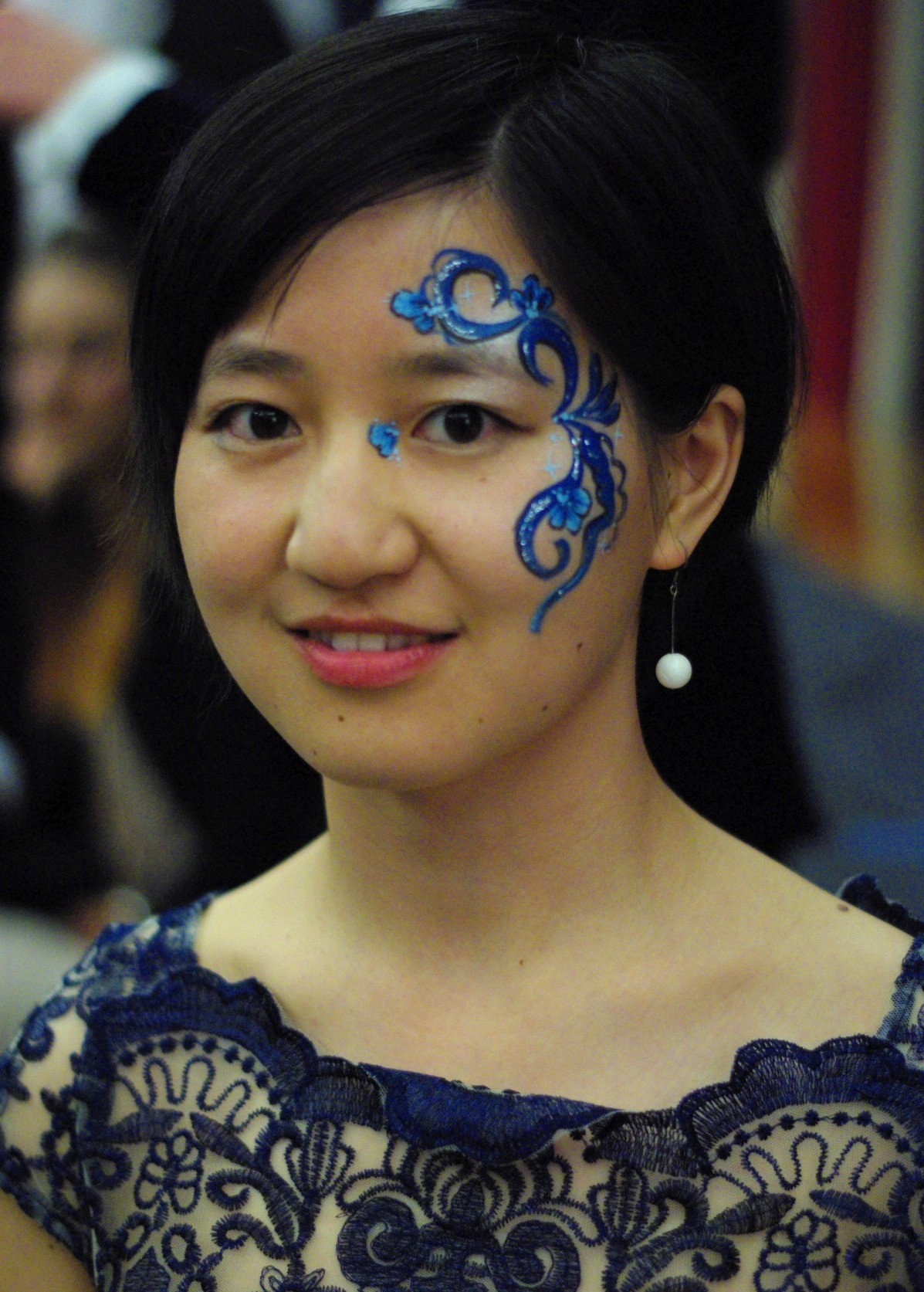 young woman with facepainted swirls